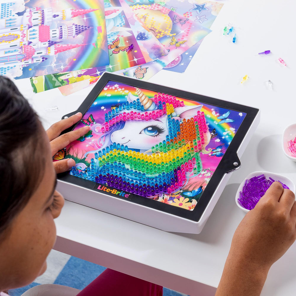 Lite-Brite ColorPOP Rainbow Dreams Twinkle Palace glows beside a sparkling castle