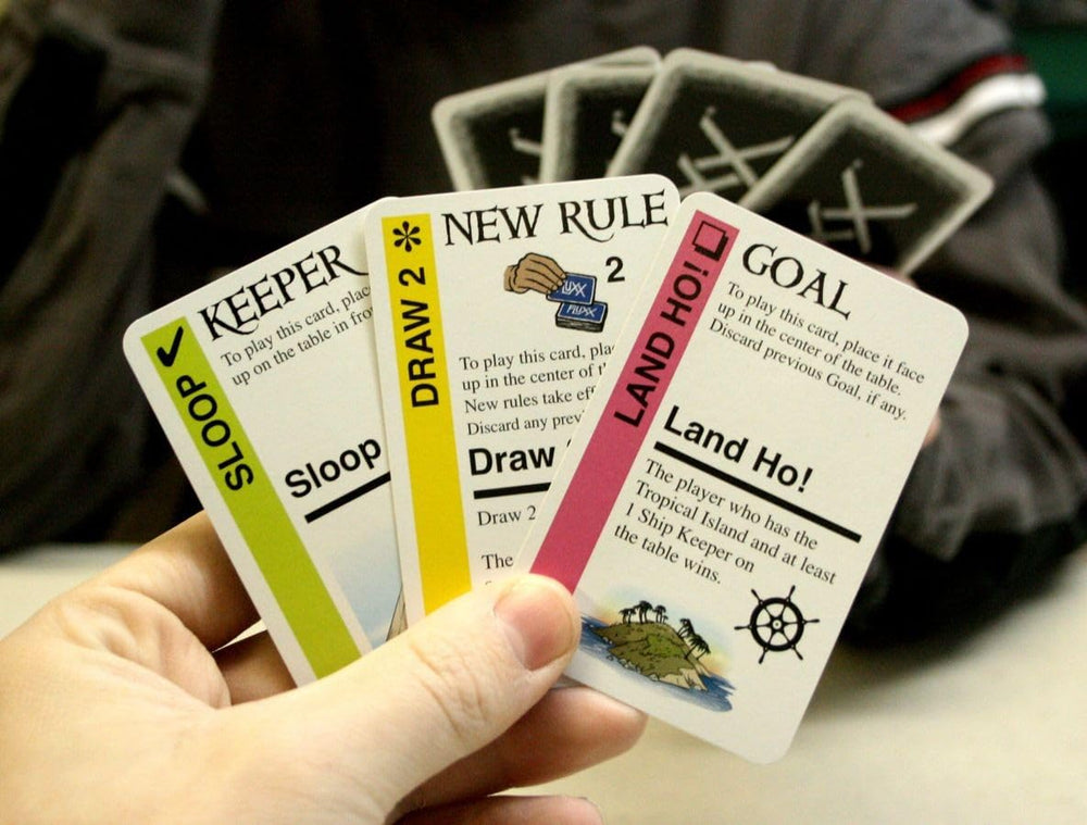 Looney Labs Pirate Fluxx play cards spread depicting captain’s hat and treasure.