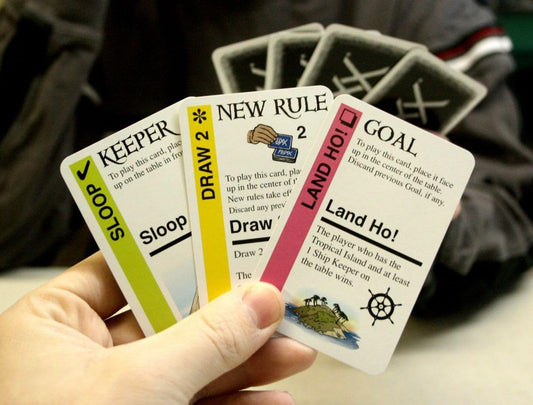 Looney Labs Pirate Fluxx play cards spread depicting captain’s hat and treasure.