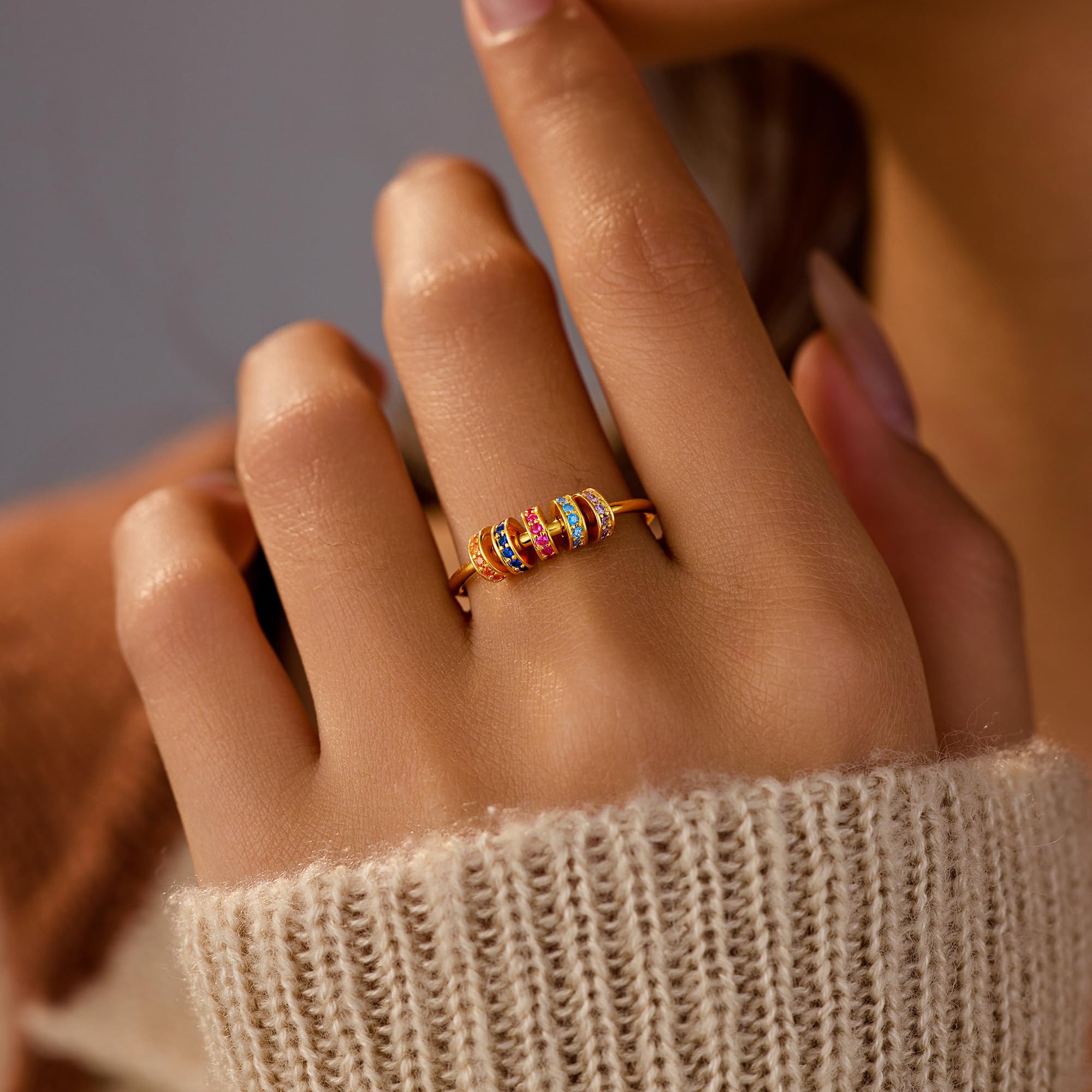 LoveCom fidget ring rotation action highlighting movable beads for calm distraction.
