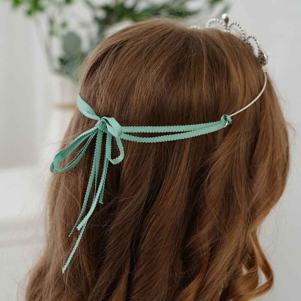 Lovelyshop Princess Tiara Crown with green gem, worn by a child at a party for magical pose.