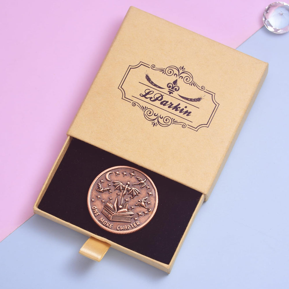 LParkin coin in use beside a notebook during a cozy reading session.