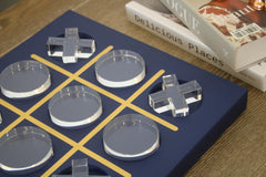 LuxLand Home Tic Tac Toe board on a coffee table, accenting with contemporary blue and clear acrylic.