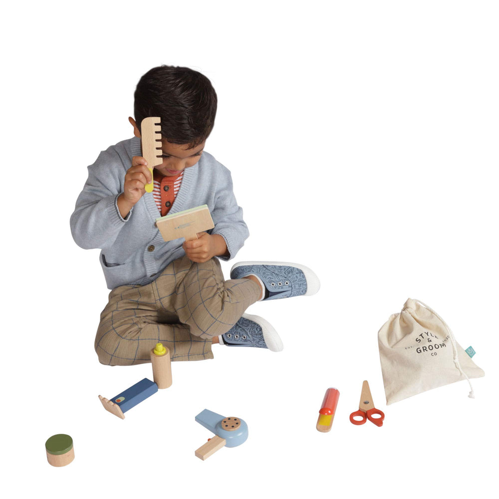 Manhattan Toy baby-safe mirror with handle for grooming play.
