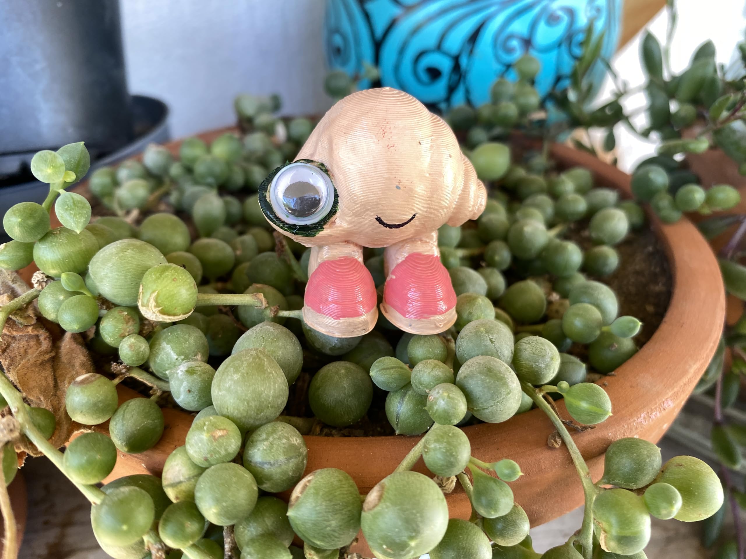 Marcel the Shell with Shoes On life-size figure 3D printed PLA texture and color highlights.