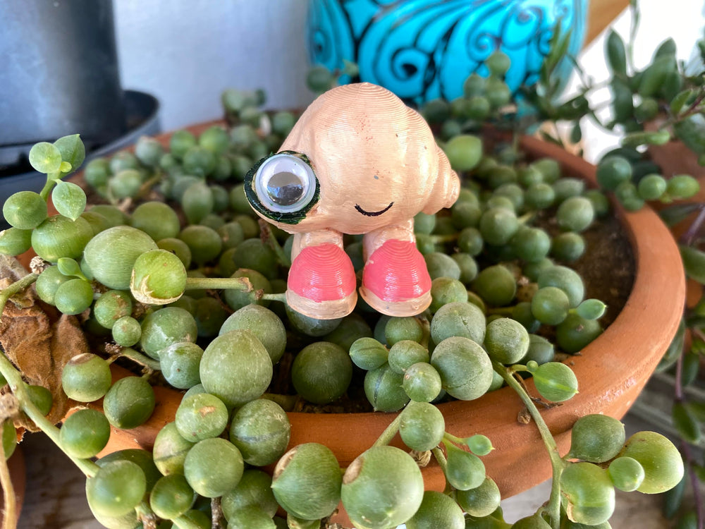 Marcel the Shell with Shoes On life-size figure 3D printed PLA texture and color highlights.