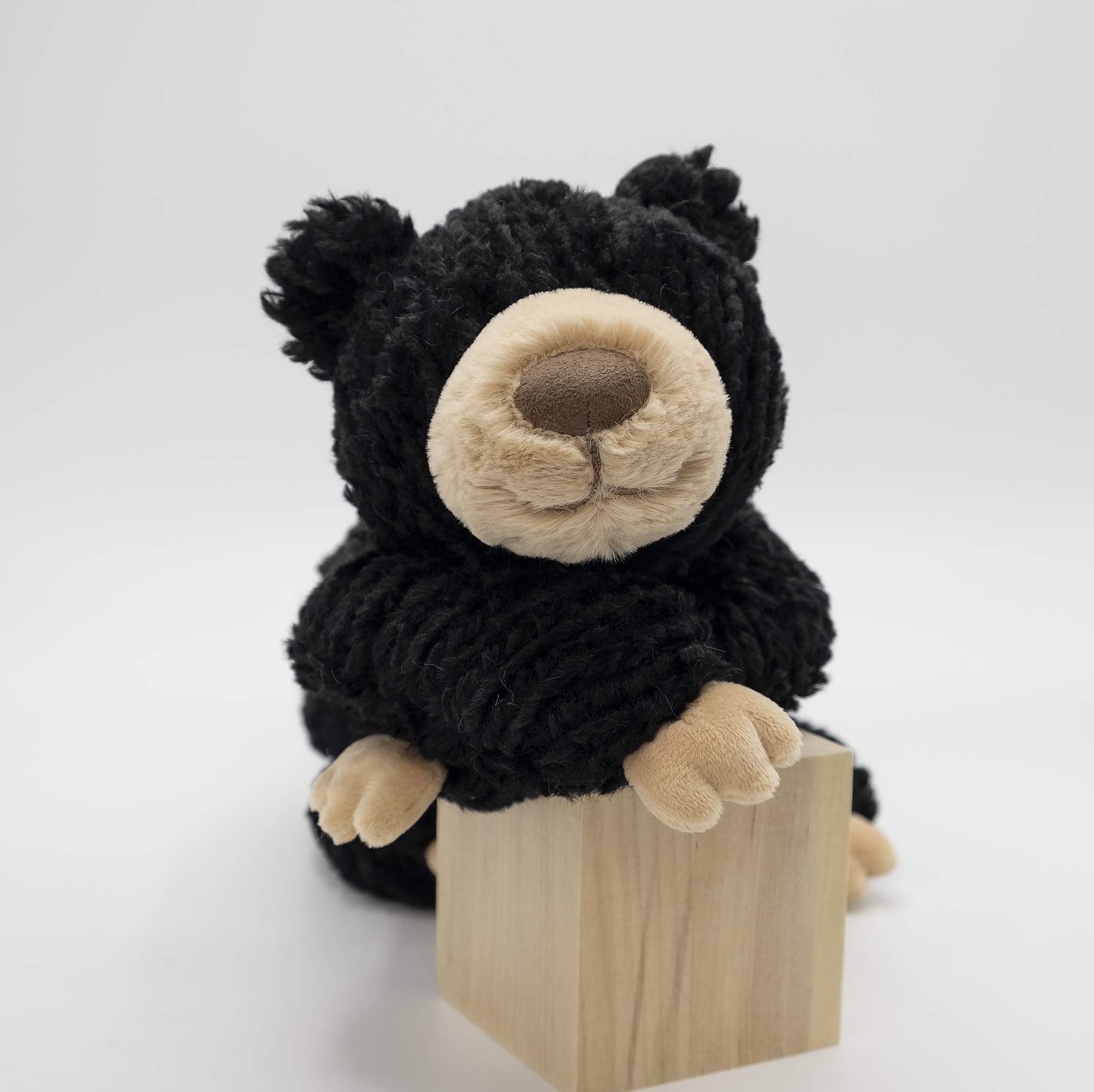 Mary Meyer Cozy Toes Black Bear held under the arm for on-the-go cuddles.