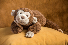 Cozy Toes Monkey face detail with sculpted features and shiny eyes.