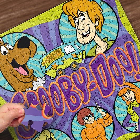 MasterPieces Scooby-Doo puzzle pieces spread on a table inviting collaboration