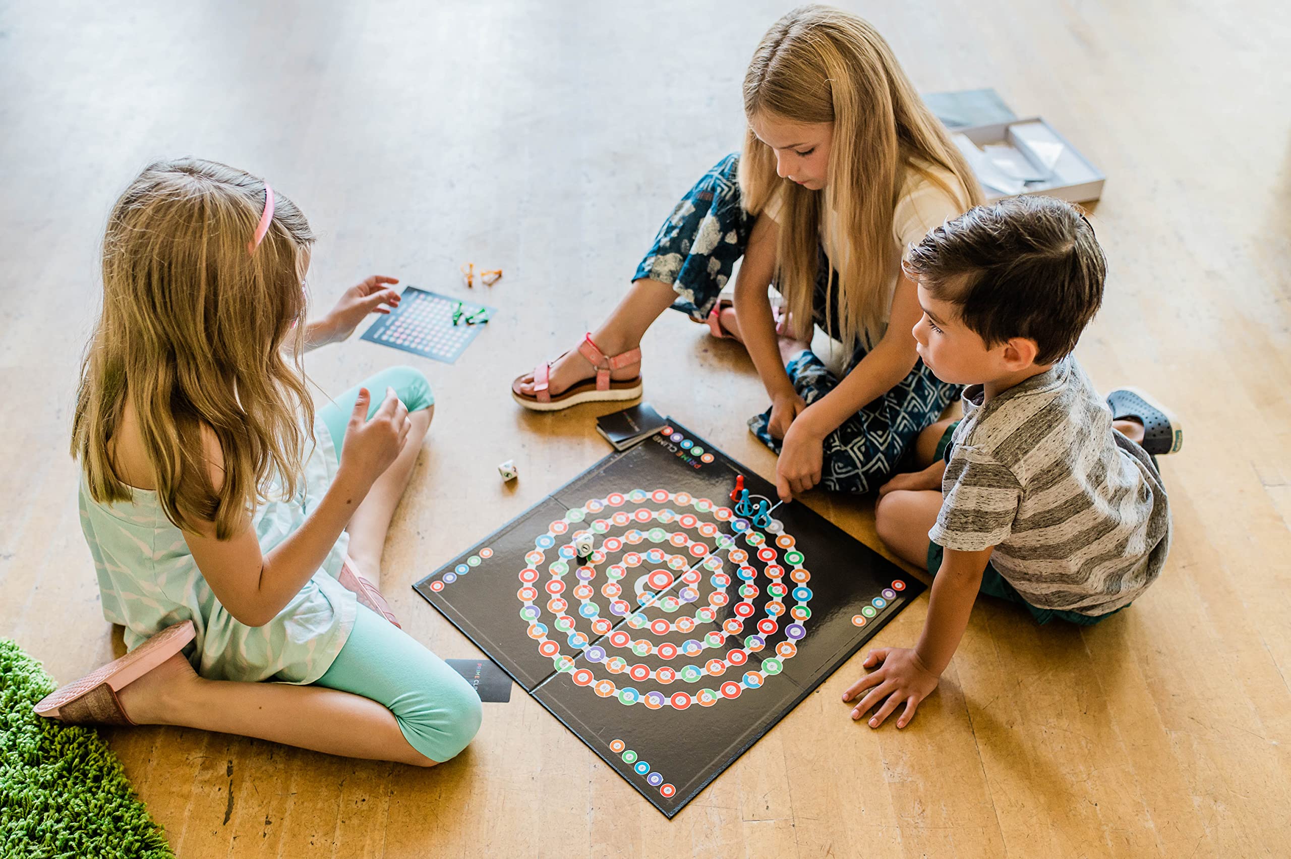 Players at the table enjoying strategic Prime Climb challenges.