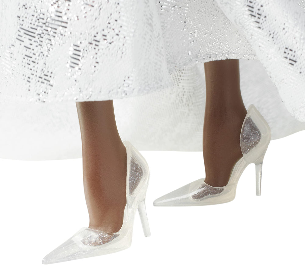 Barbie Signature 2021 Holiday doll features a shimmering tulle peplum and full skirt.