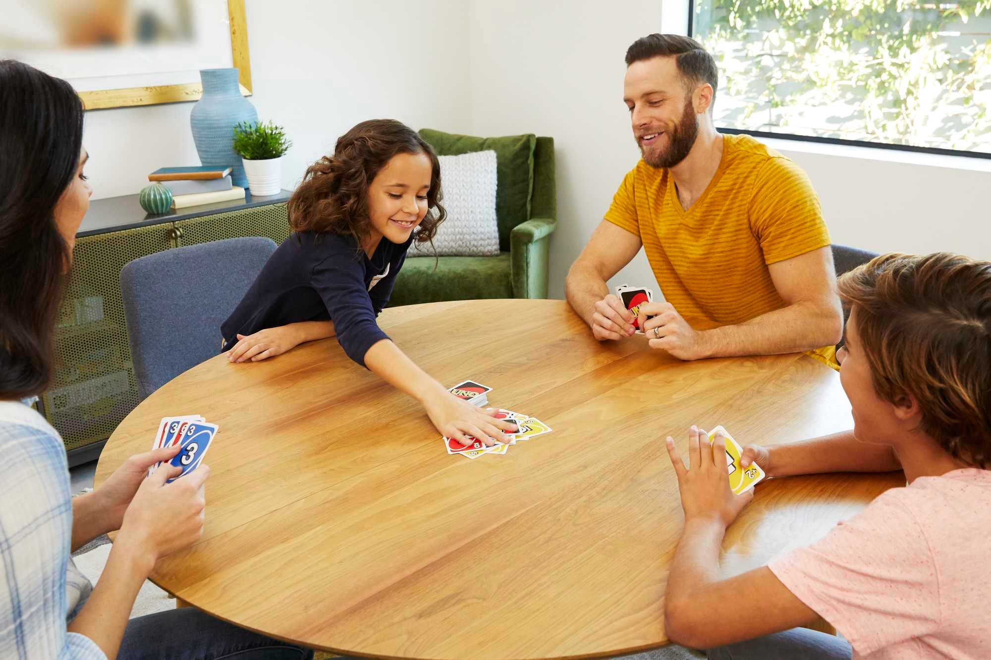 Uno, Dos, and Skip-Bo card decks spread out for quick teaching and play.