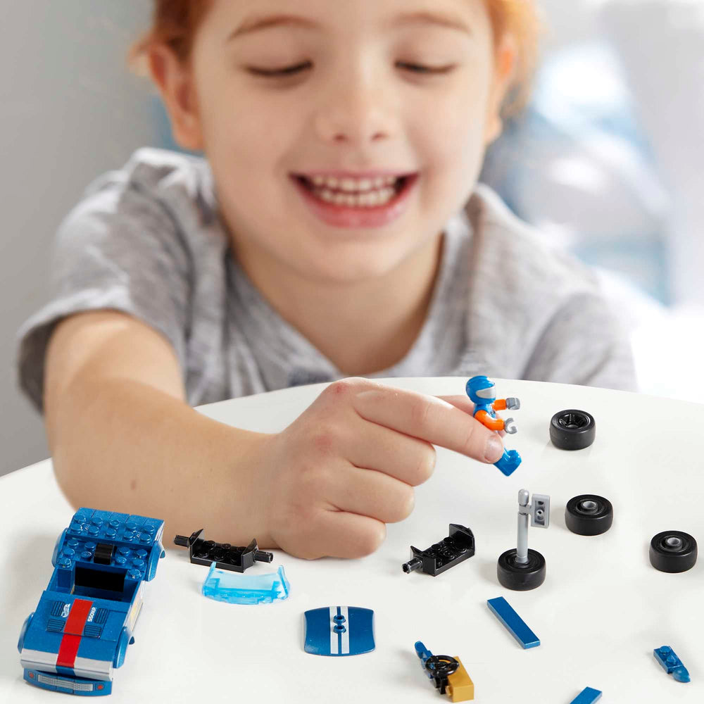 Mega Hot Wheels micro action figure driver seated inside the race car during play
