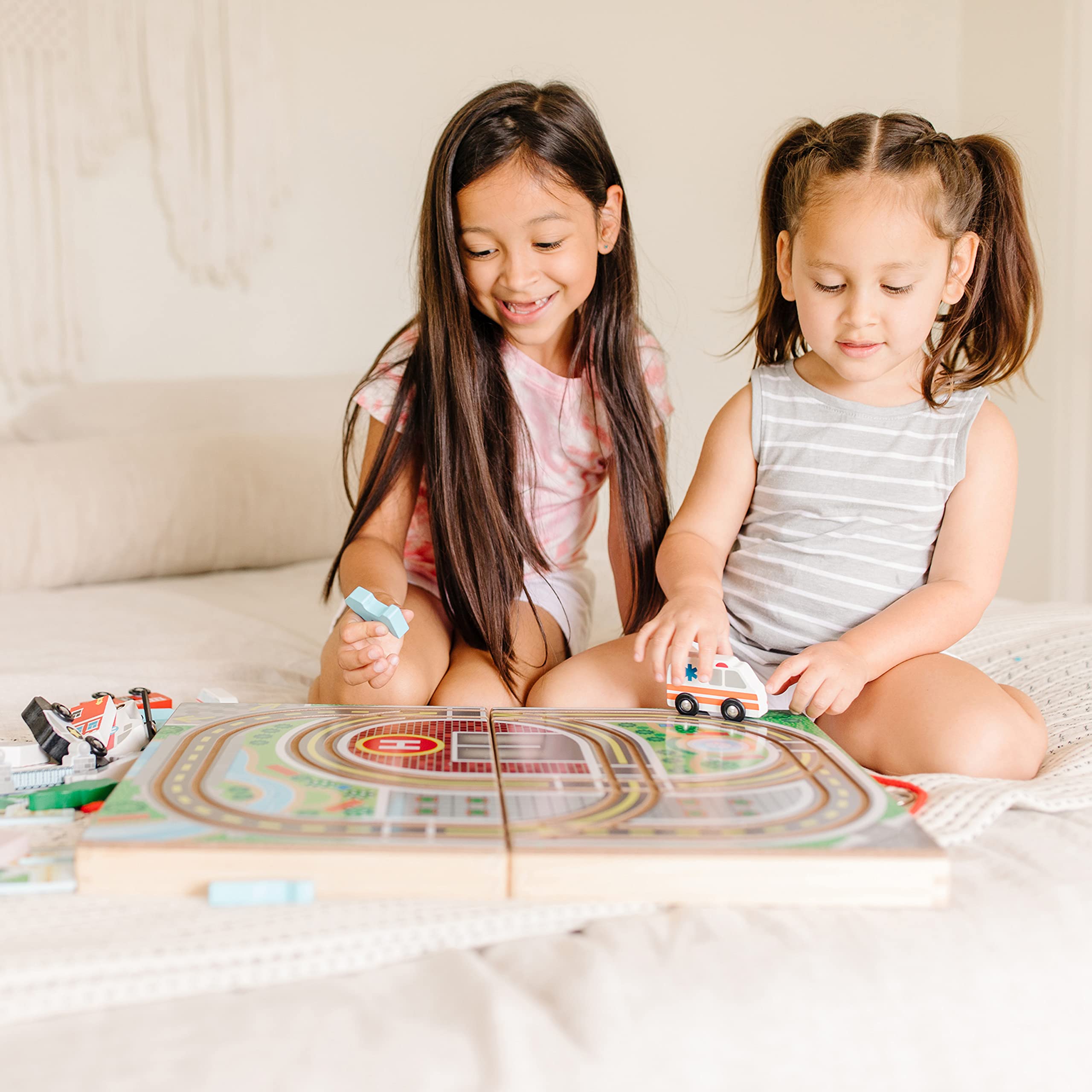 Melissa & Doug ambulance rushes toward colorful city scenes for drama.