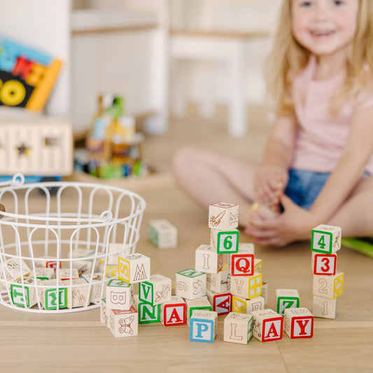 Melissa & Doug blocks close-up with hand-painted letters and numbers.