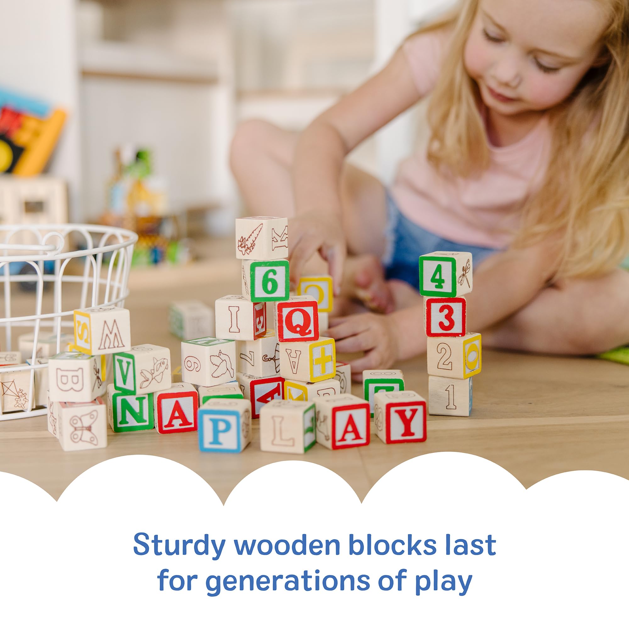 Toddler hands use Melissa & Doug blocks to develop fine motor skills.