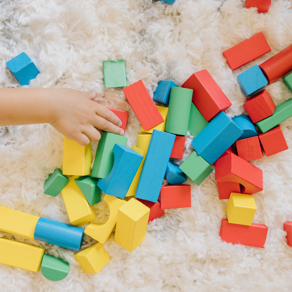 Melissa & Doug wooden blocks close-up showing woodgrain and color variety for tactile exploration.