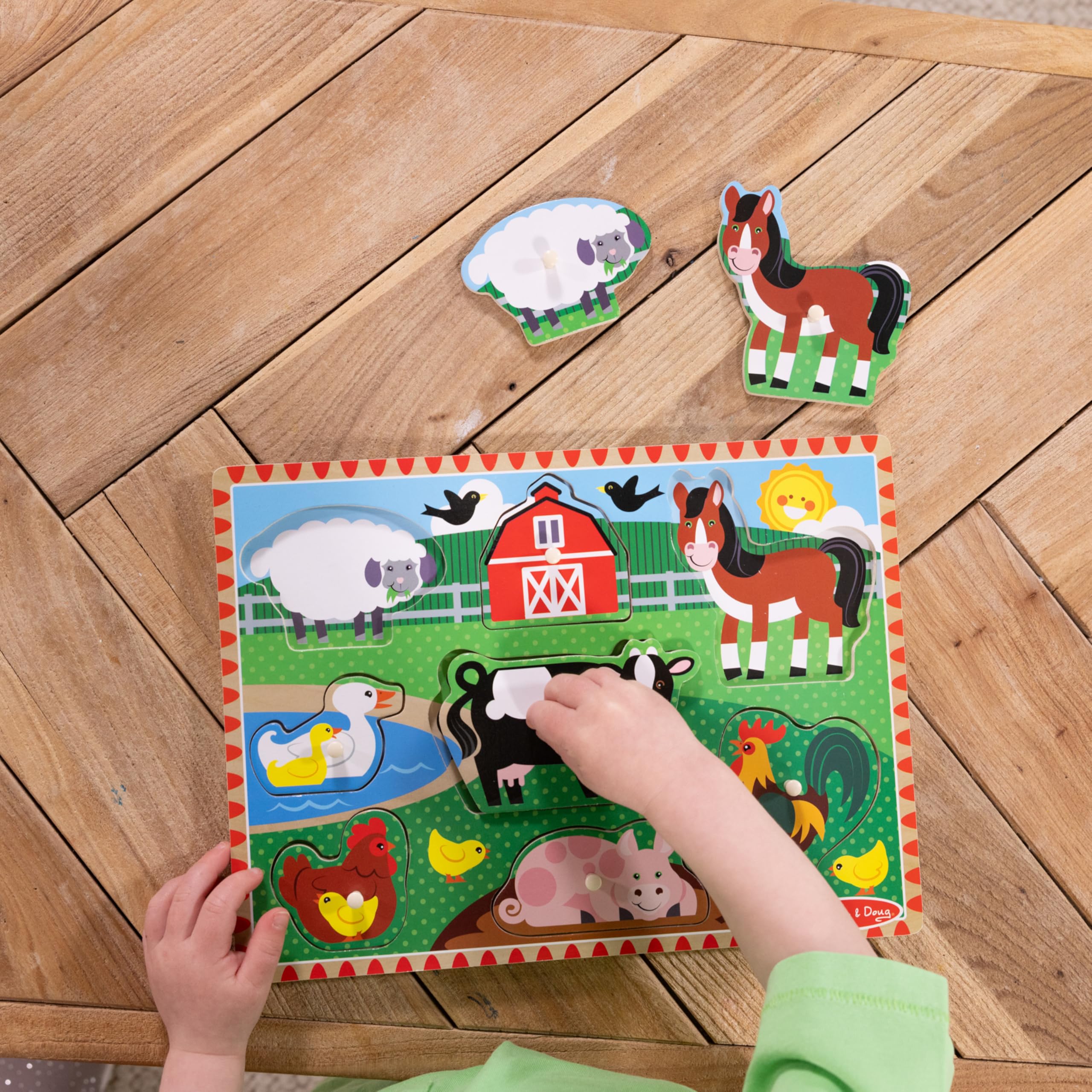 Melissa & Doug easy-grasp pegs support hand strength during puzzle play.