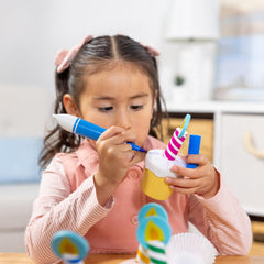 Oven mitt helps kids move cupcakes safely during pretend baking.