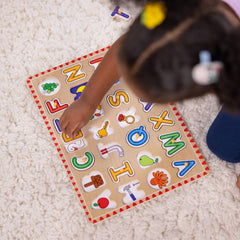 Melissa & Doug Lift & See puzzle close-up of easy-grasp pegs for little hands.