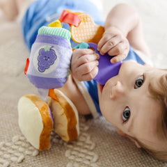 Clip attaches securely to strollers for hands-on play during errands.