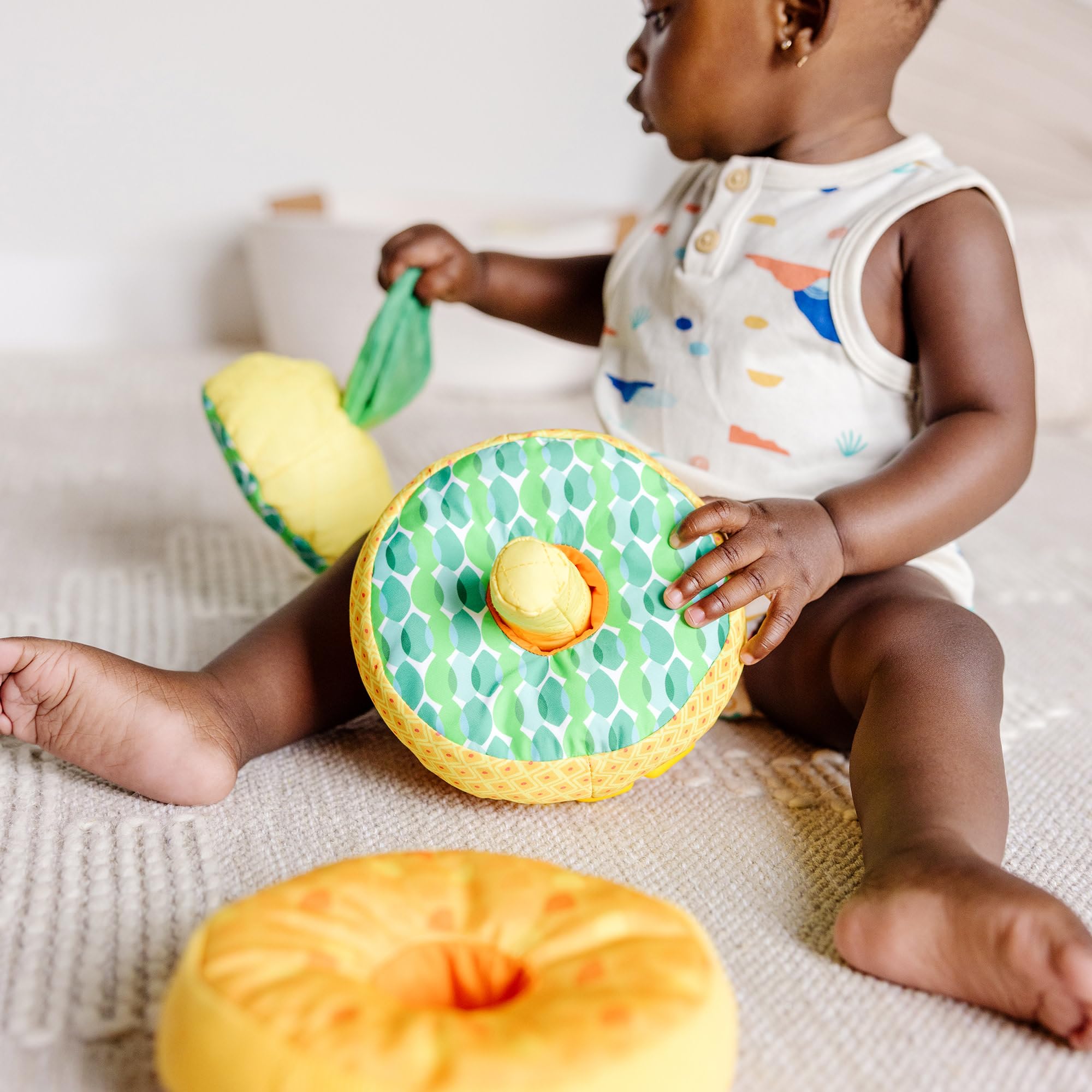 Melissa & Doug Pineapple Soft Stacker post with rattle detail.