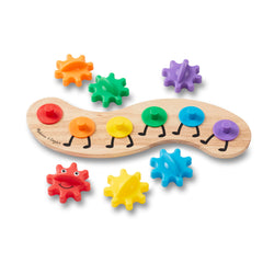 Six bright Rainbow Caterpillar gears spinning together on a wooden base