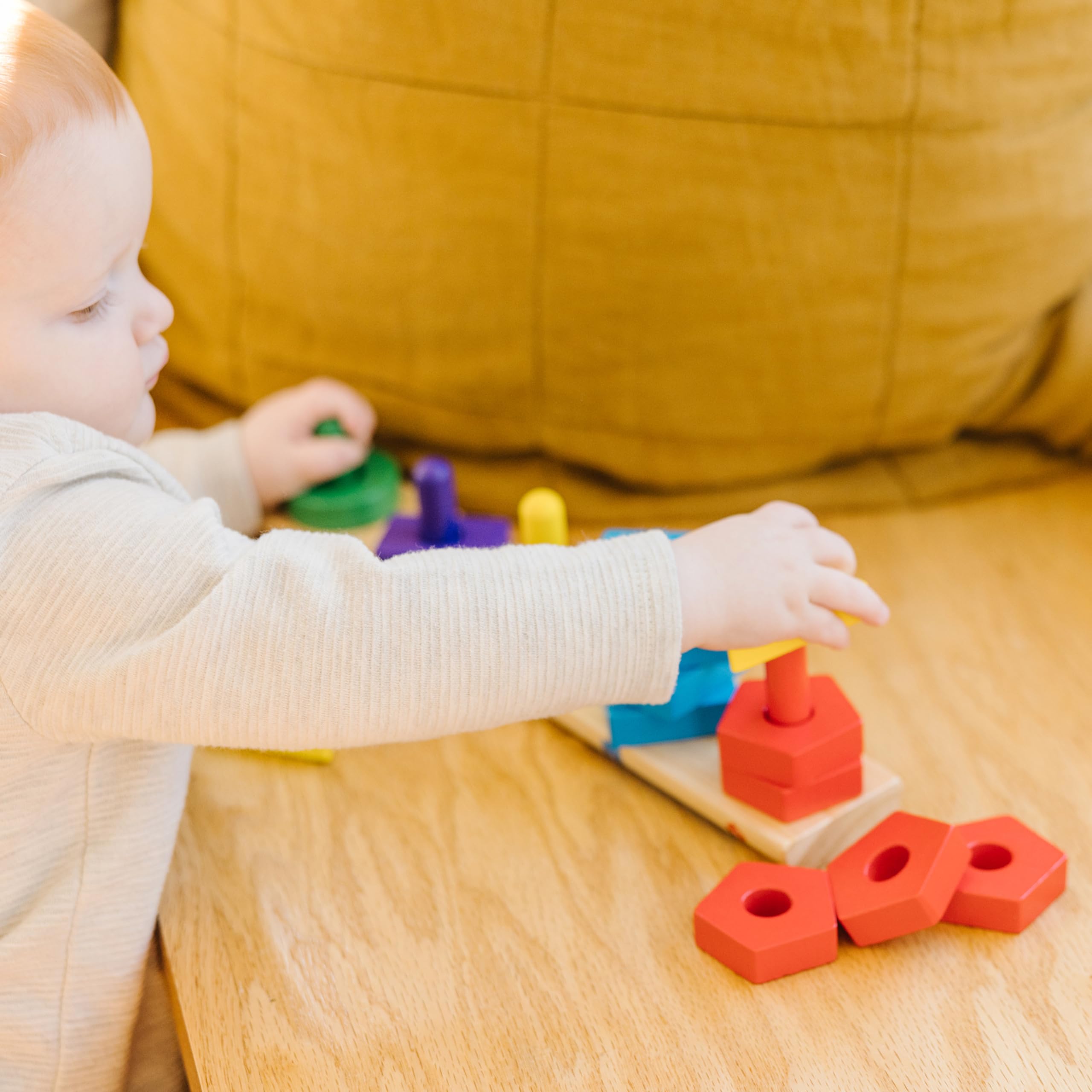 Melissa & Doug wooden pieces on the board support fine motor skills