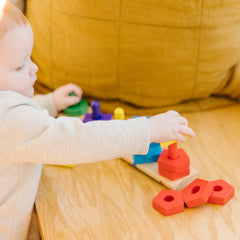 Melissa & Doug wooden pieces on the board support fine motor skills