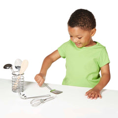 Melissa & Doug Stir & Serve utensils fit naturally within a kitchen playset.