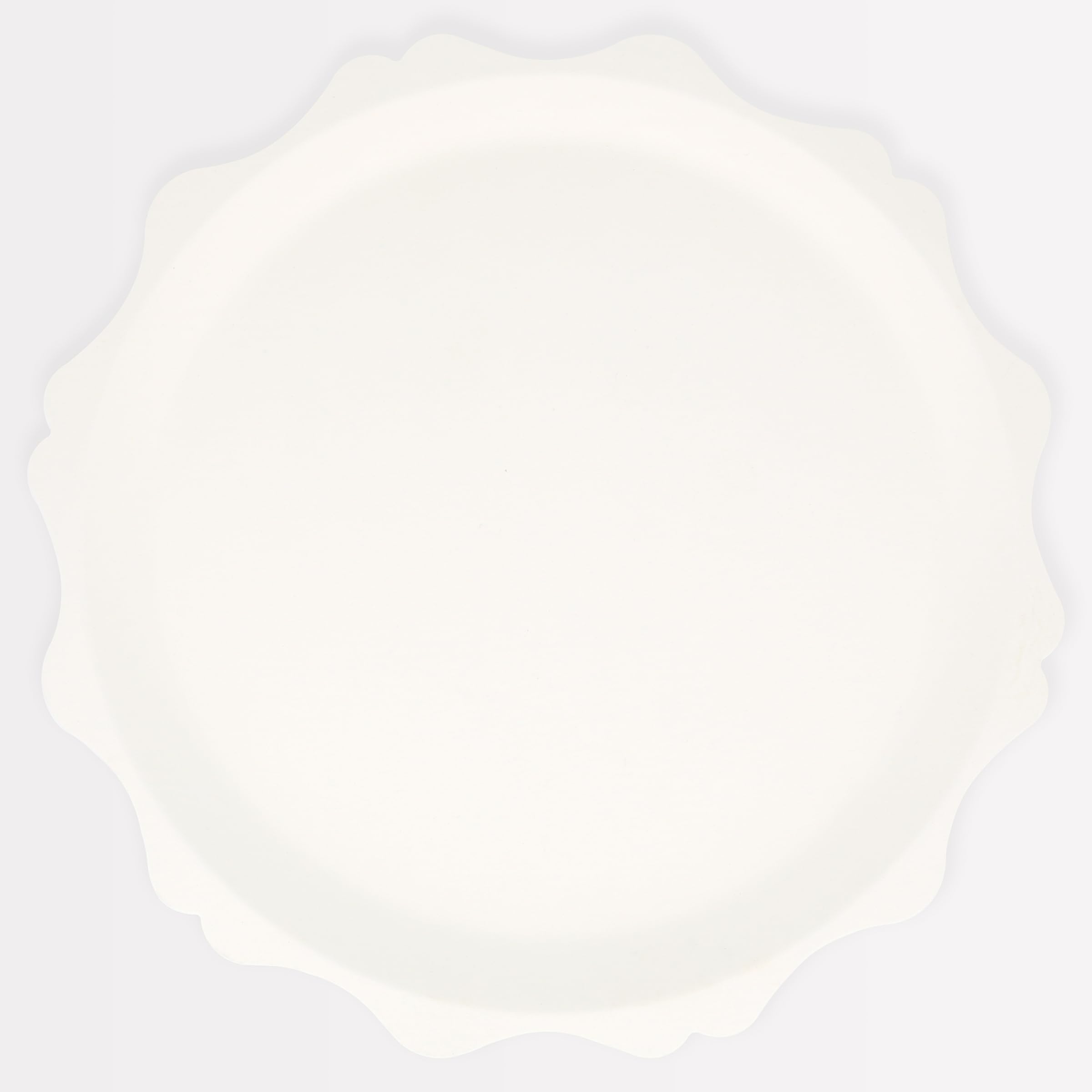 Meri Meri decorative-edge cream plates elevating party tables with sustainable design.