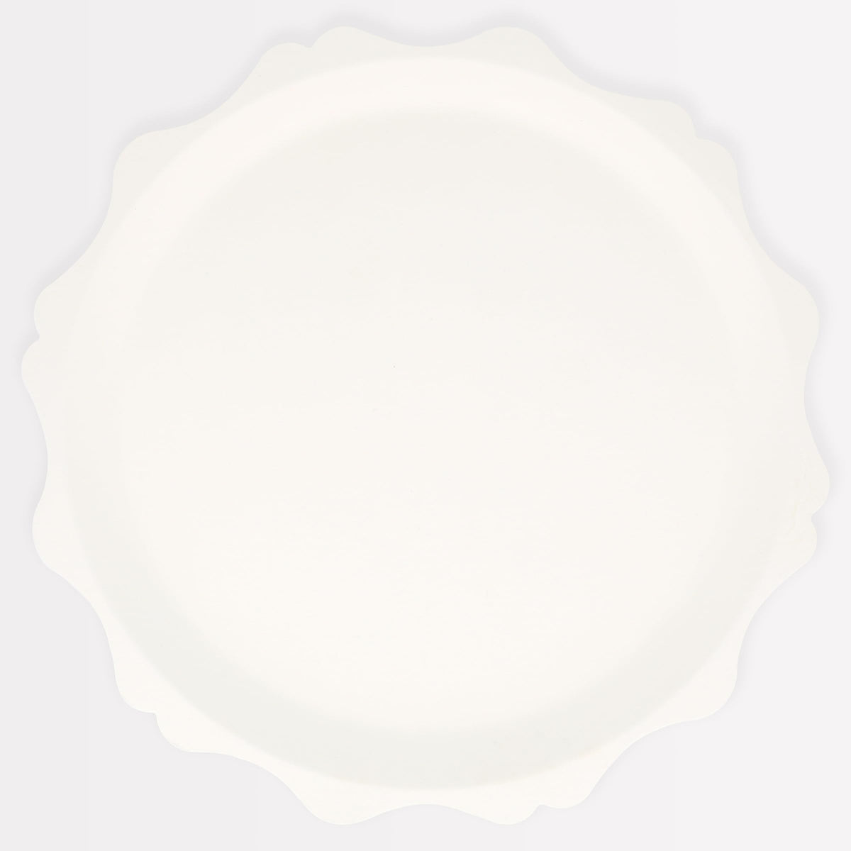 Meri Meri decorative-edge cream plates elevating party tables with sustainable design.