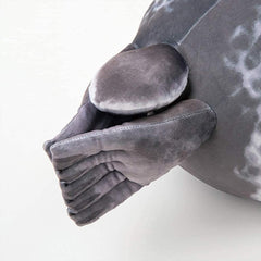 MerryXD seal pillow in a living room setup on a sofa