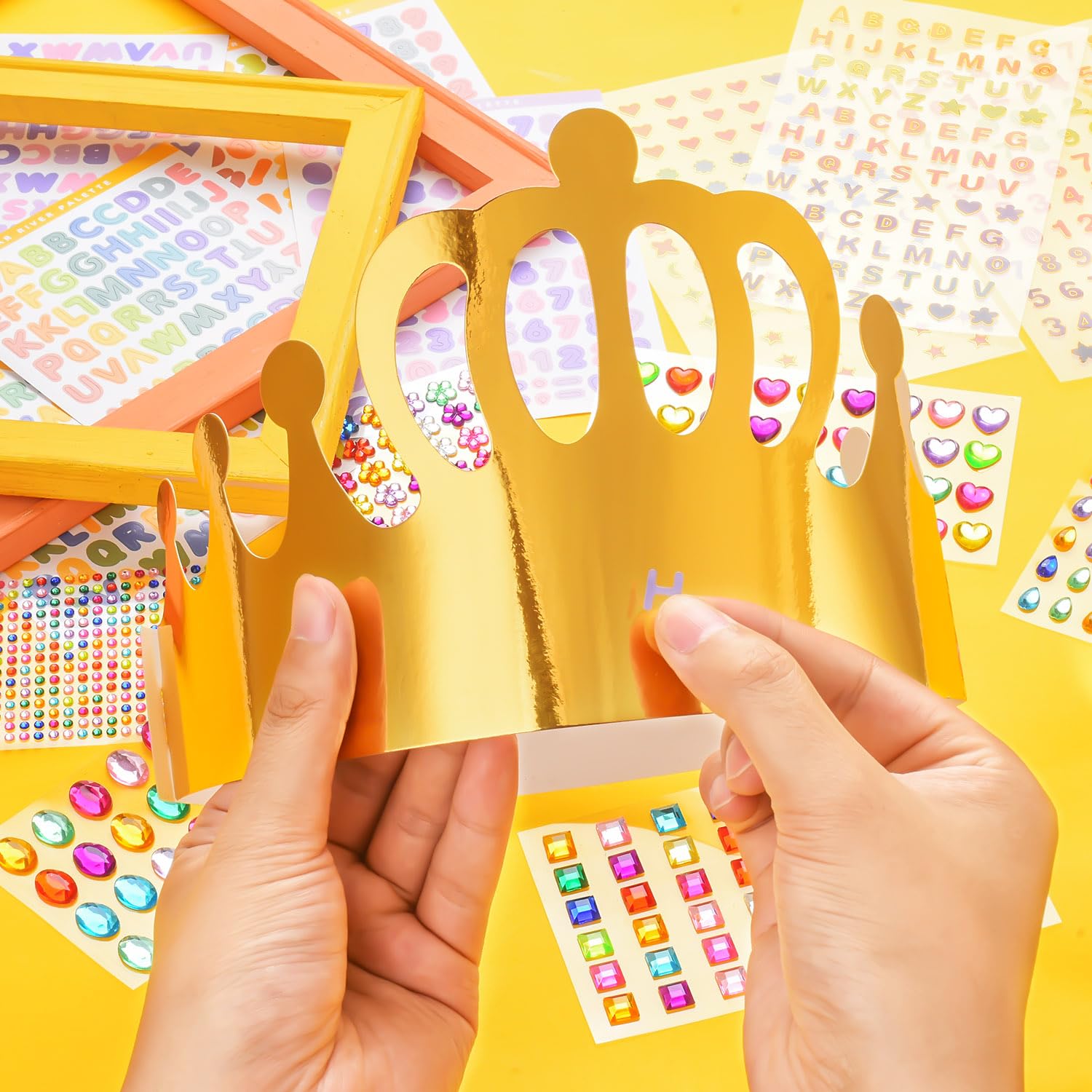 MGZTTHW kids decorating crowns with colorful stickers during a joyful party.