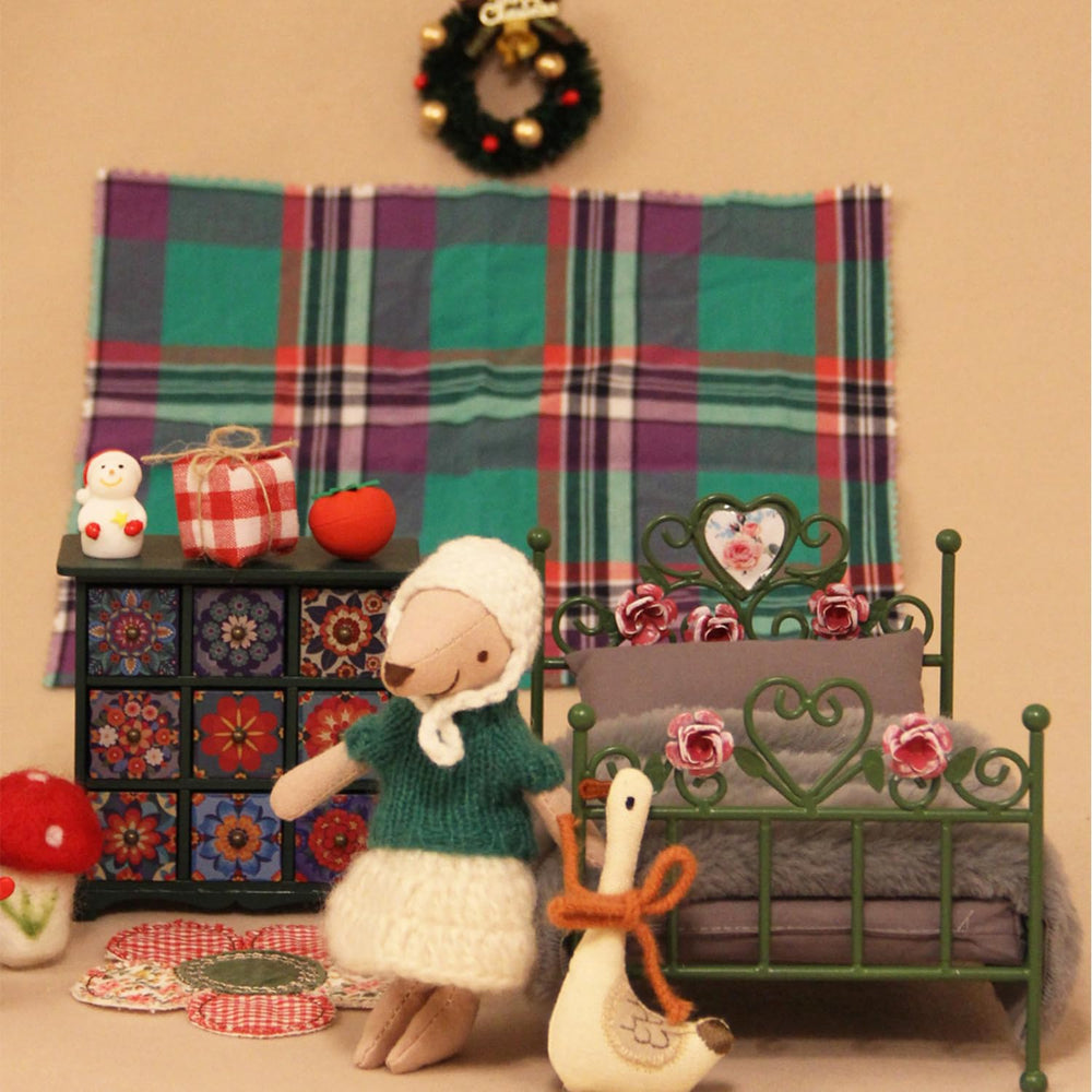 Handcrafted 1:12 bed designed for realistic dollhouse layouts.