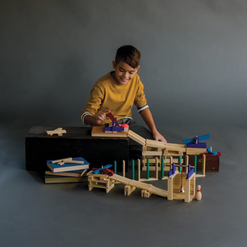 MindWare KEVA ball-run structure showing marble motion on planks.