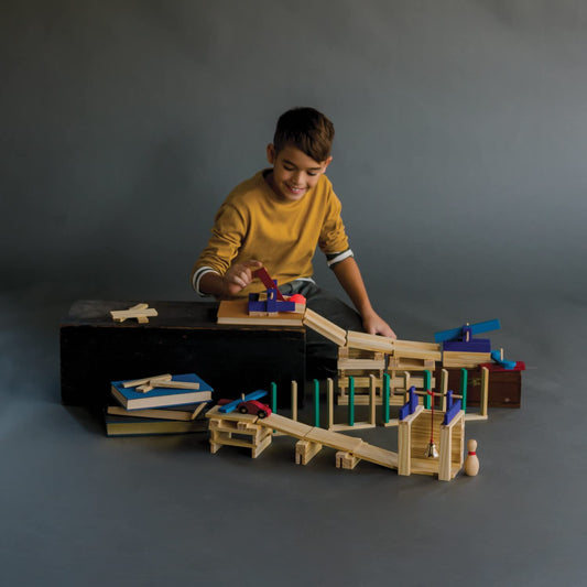 MindWare KEVA ball-run structure showing marble motion on planks.