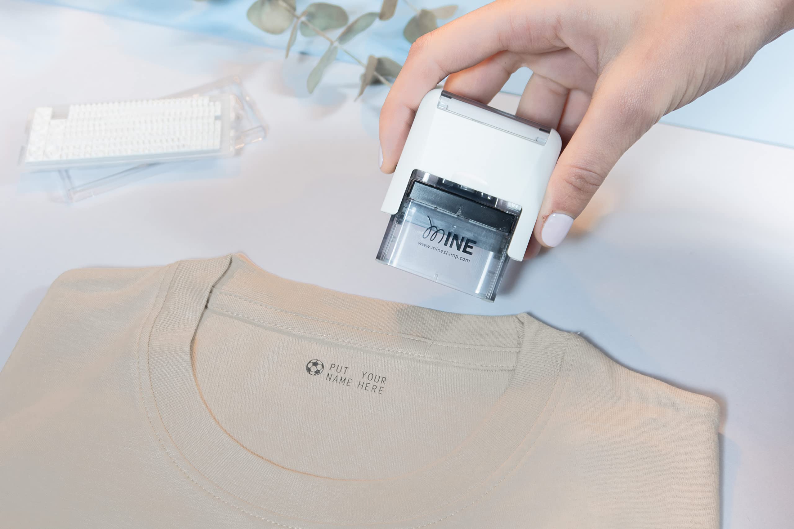 Mine Stamp Compact Clothing Marker marking clothes in wardrobe demonstrates quick personalization