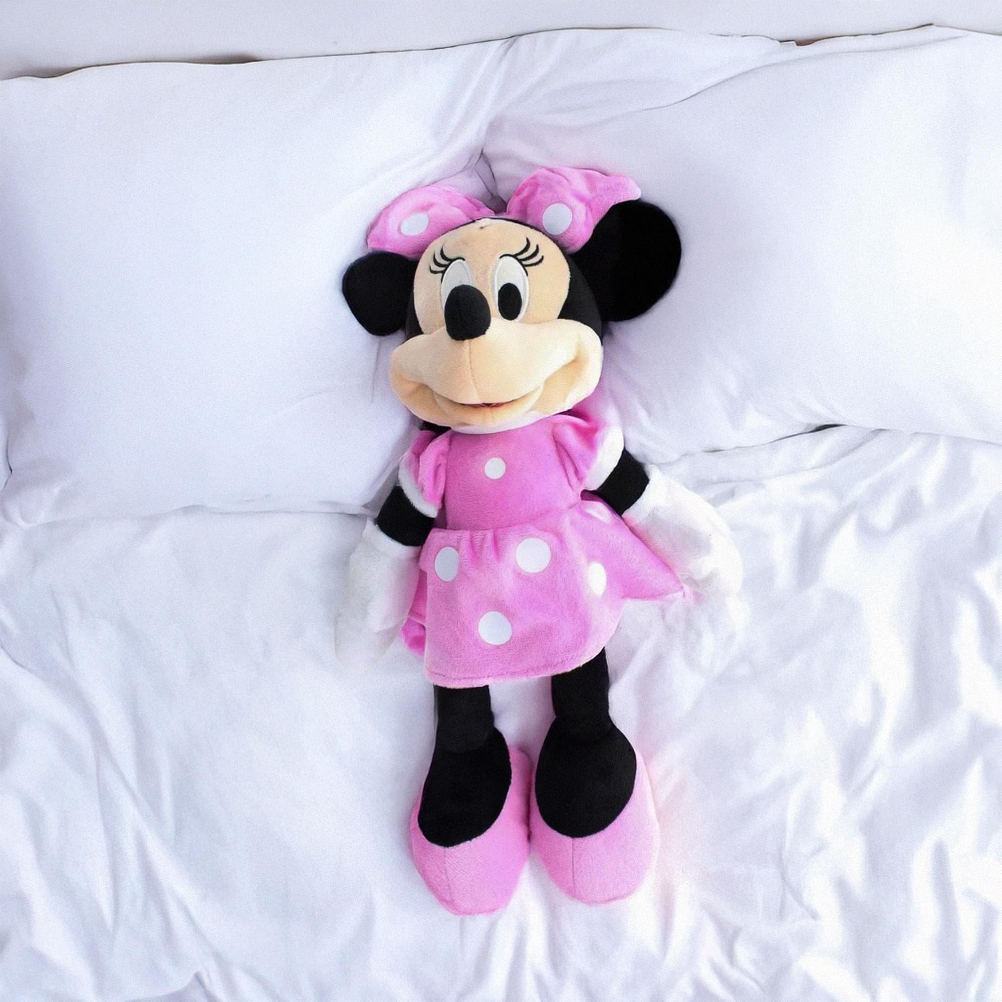 Child hugging Minnie 10782 plush, a cozy playtime friend.