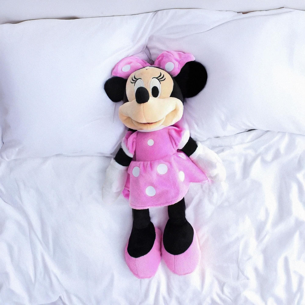 Child hugging Minnie 10782 plush, a cozy playtime friend.