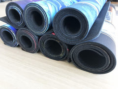 MLIKEMAT Evil Twins playmat rolled for portable use during gaming.