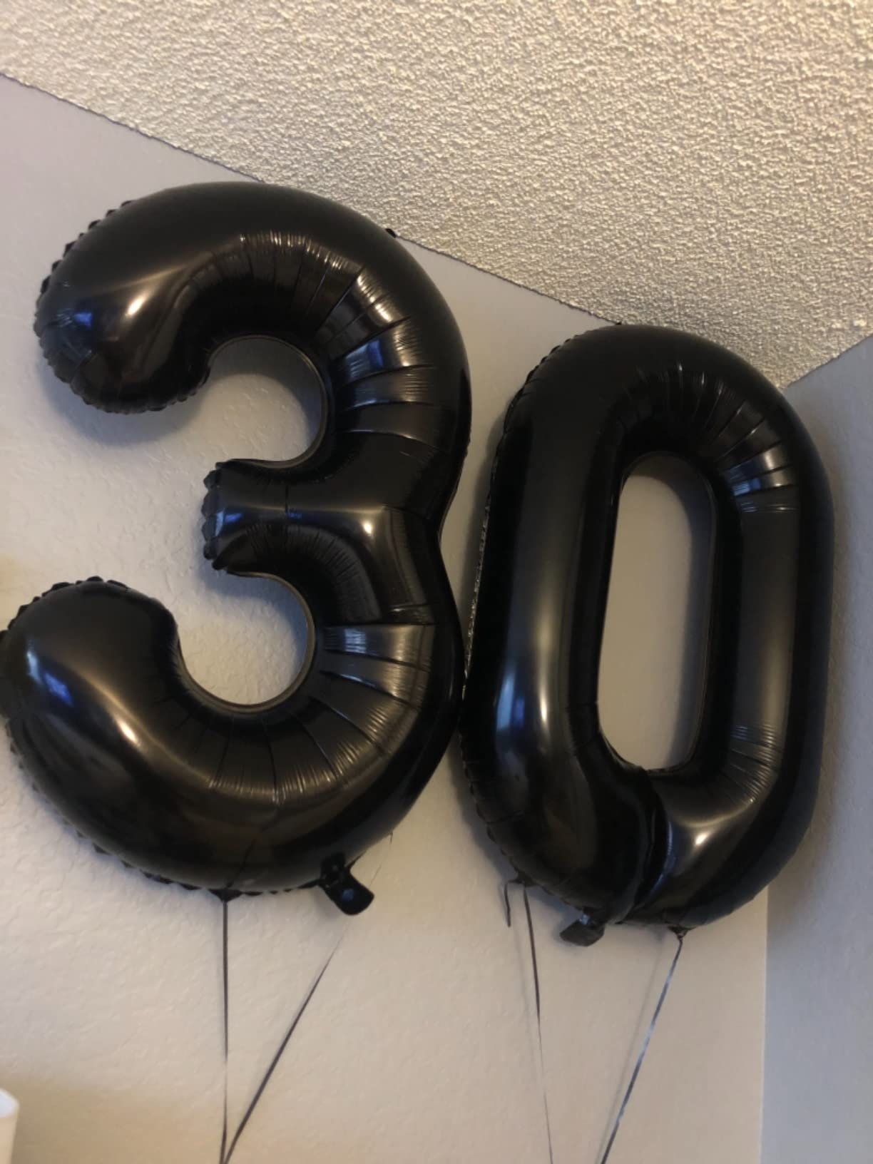 Mluchee black 8 balloon used as wedding decor backdrop