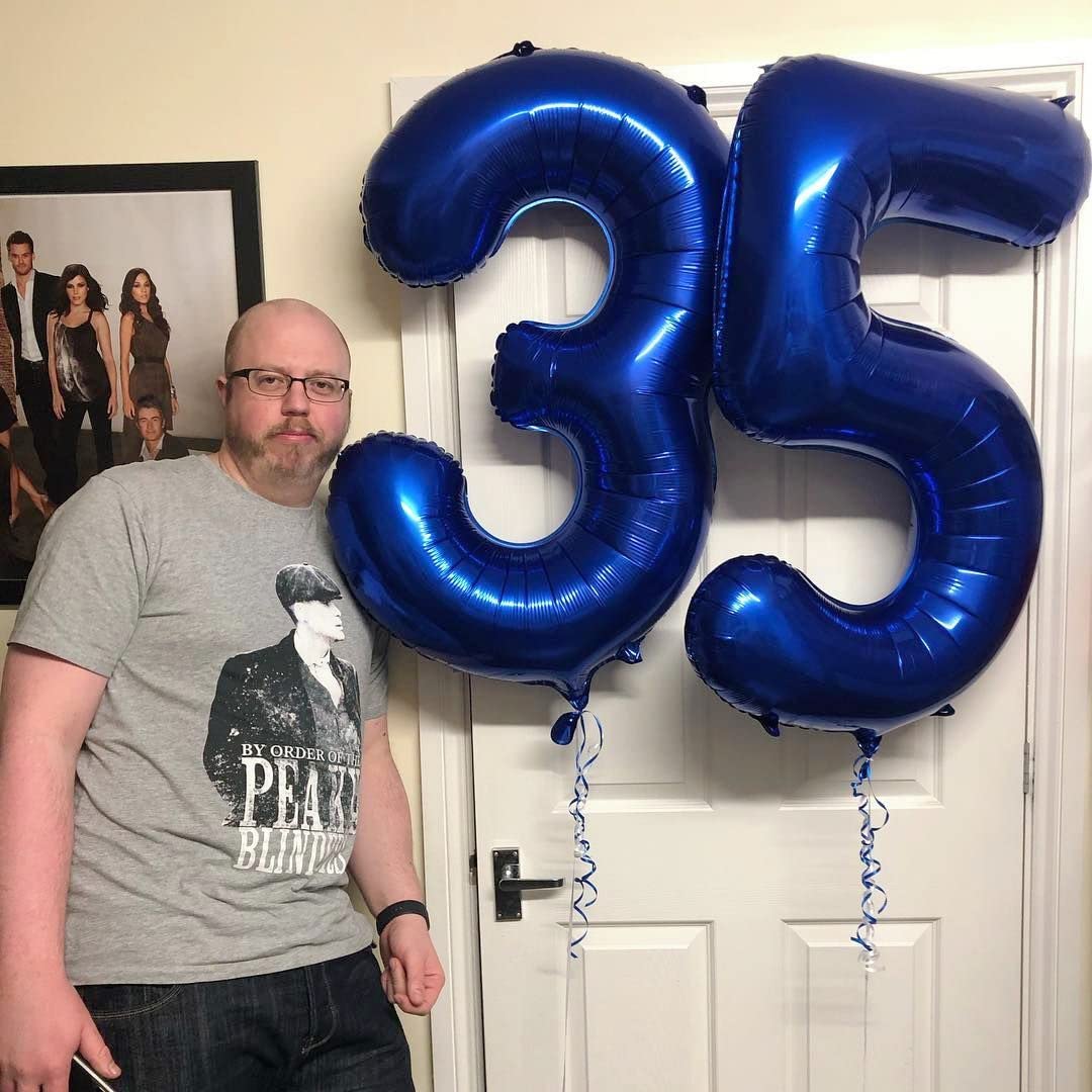 Mluchee navy blue 40-inch balloon serves as a dramatic photo booth prop.