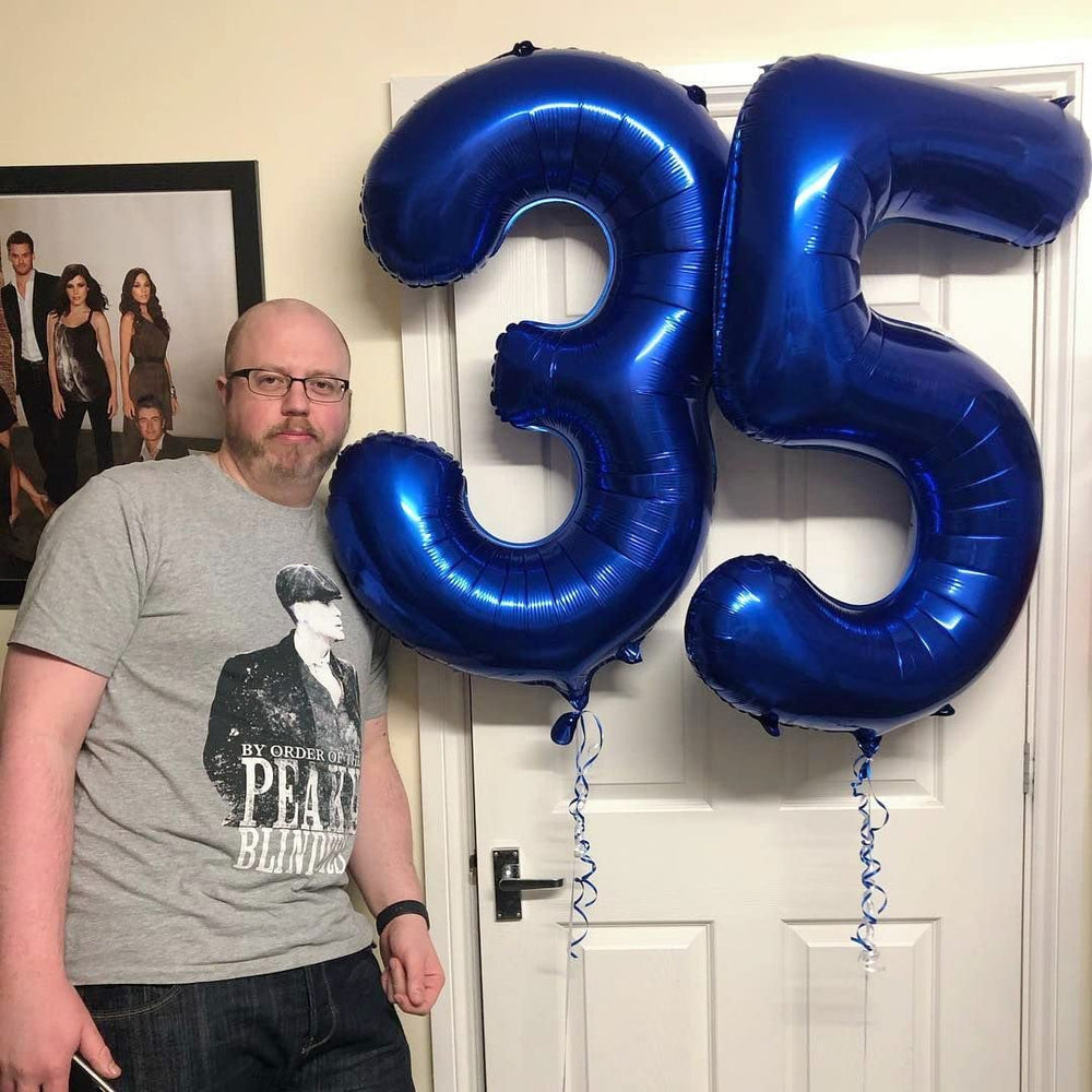 Mluchee navy blue 40-inch balloon serves as a dramatic photo booth prop.