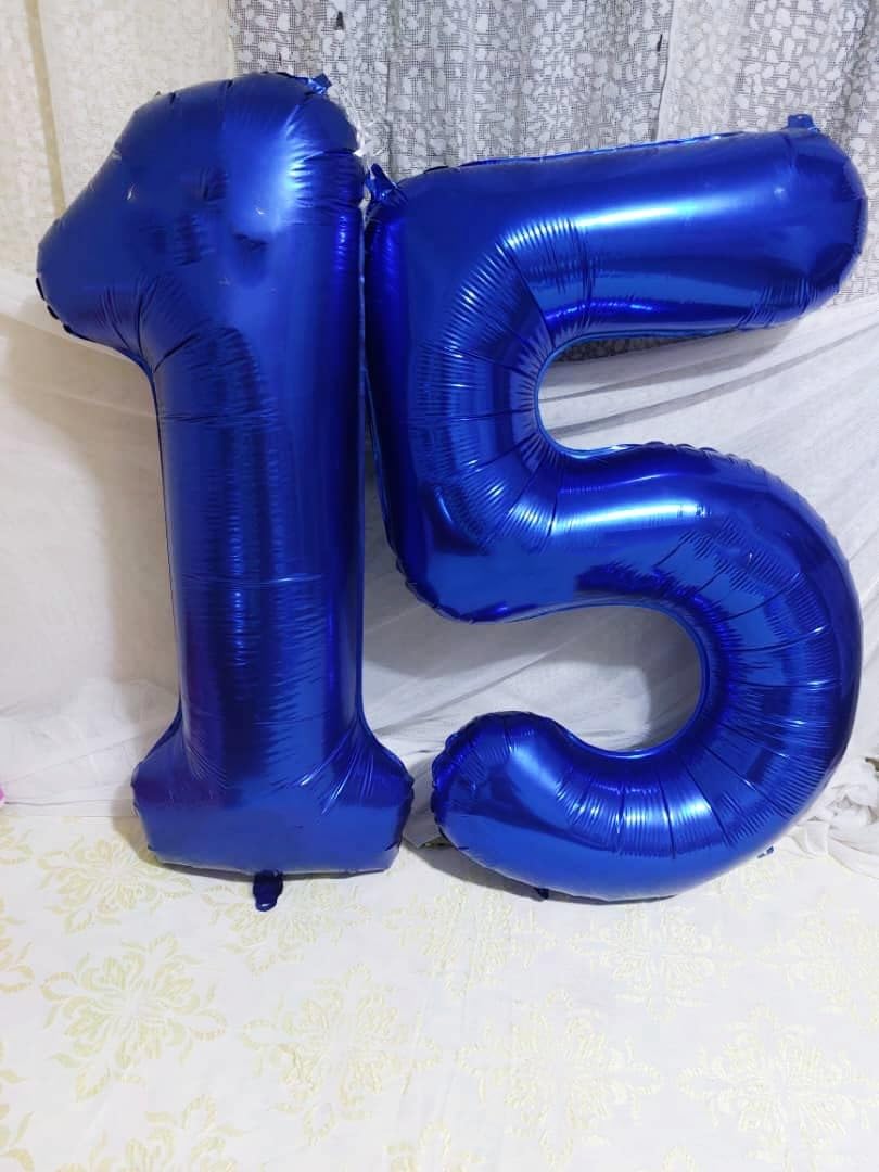 Mluchee 40-inch navy blue number balloon creates a photo backdrop for events.