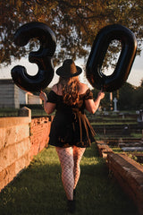 Mluchee 6th birthday balloon used as a photo booth prop.
