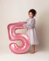 Mluchee birthday backdrop featuring oversized pearl pink numerals