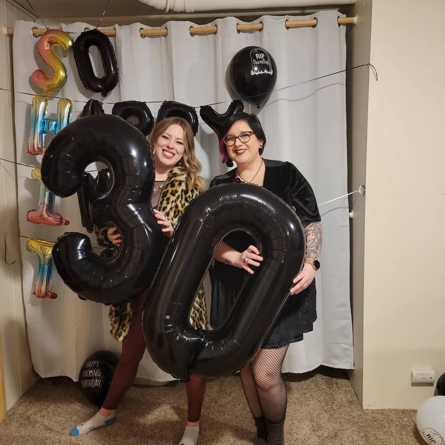 Mluchee number 0 balloon used as a photo booth prop for memories.