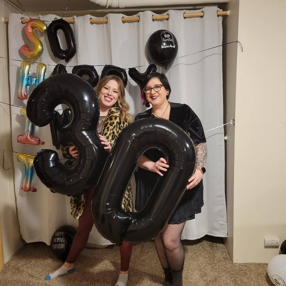 Mluchee number 0 balloon used as a photo booth prop for memories.