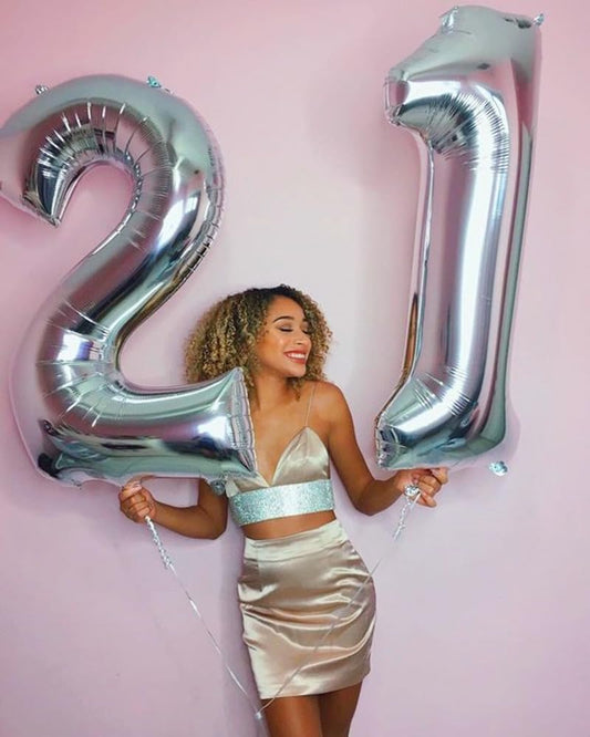Mluchee number balloon decorates birthdays with dramatic backdrop and charm.